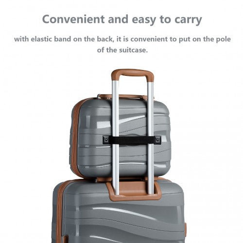 Stacked travel setup with grey and brown Kono vanity case attached to larger suitcase via elastic band
