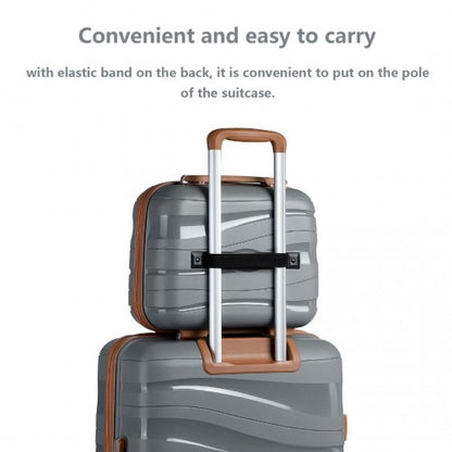 Stacked travel setup with grey and brown Kono vanity case attached to larger suitcase via elastic band