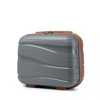 Three-quarter view of matte grey hard shell vanity case featuring wavy ribbed texture and brown zipper trim