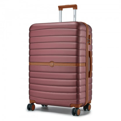 Three-quarter view of burgundy ABS+PC suitcase highlighting vertical ribs and contrasting brown trim details