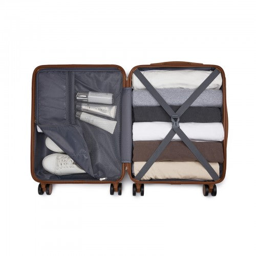 Brown hard shell suitcase packed with neutral clothing and sneakers inside X-strapped interior