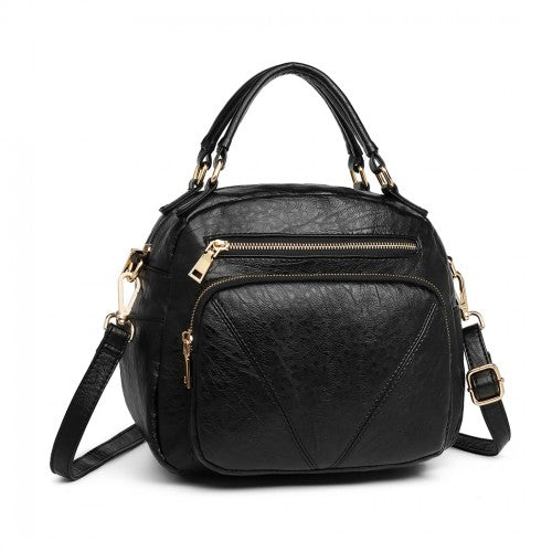 Symmetrical front view of structured black bowler bag highlighting triangular stitching detail