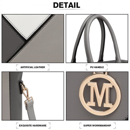 Detail shot of gray geometric handbag showing rolled PU handle and gold M monogram clasp